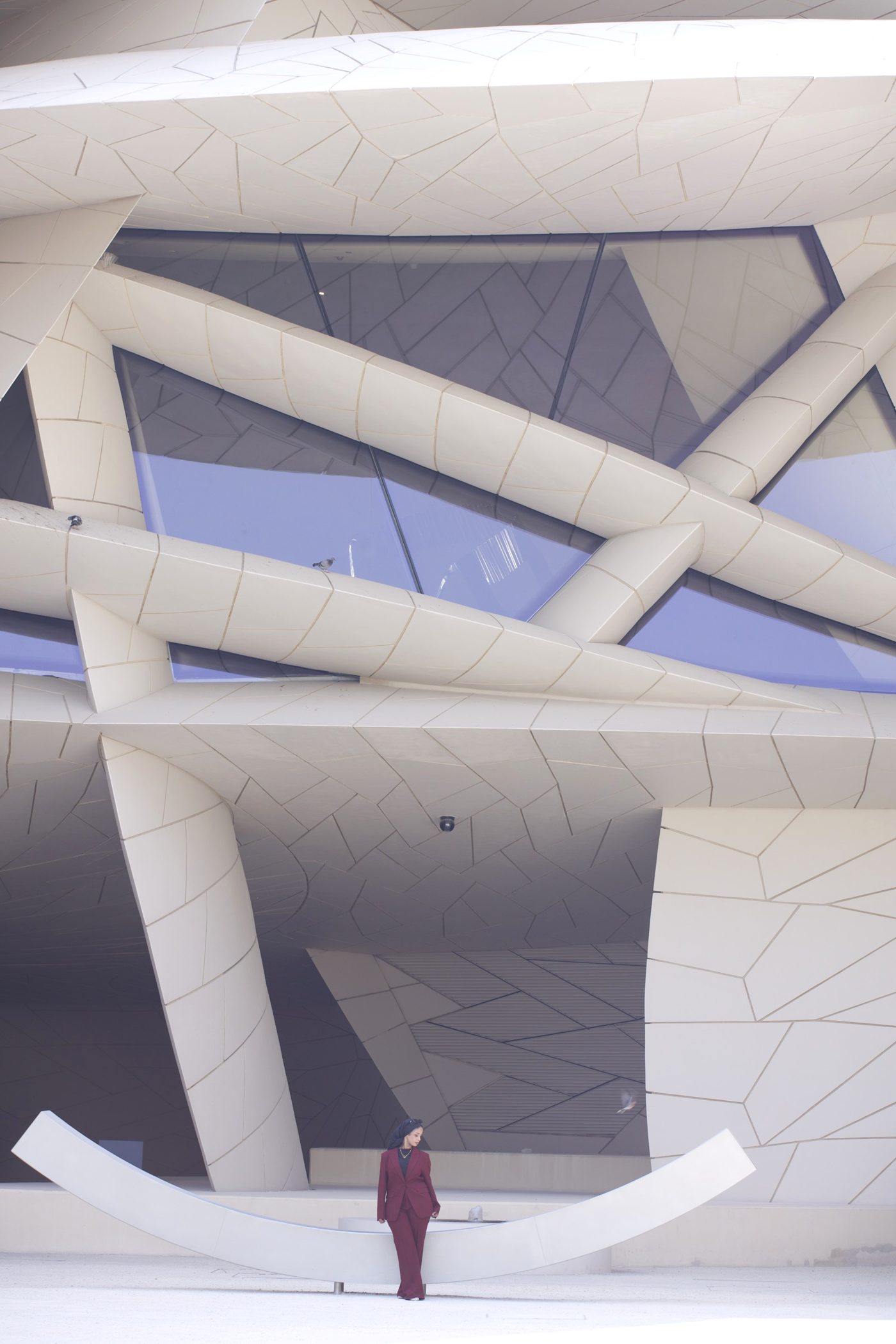 Wine suit against the curved walls of a Doha landmark